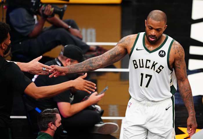 Milwaukee Bucks forward P.J. Tucker (17) is greeted by the bench